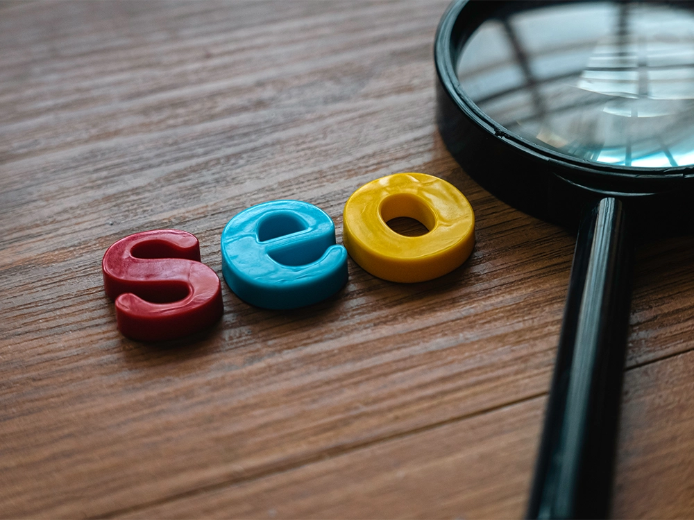 letters spelling out SEO on a brown table